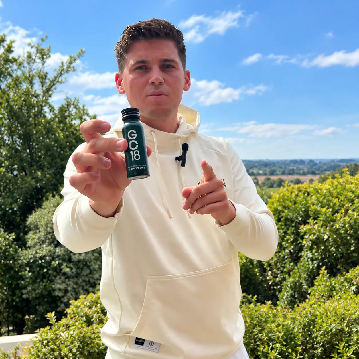 Golfer holding a GC18 bottle